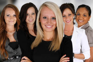 Group of smiling women in professional attire.